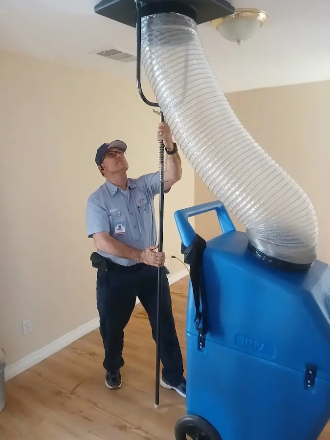Furnace Tune-Up technician using HEPA equipment in Canutillo